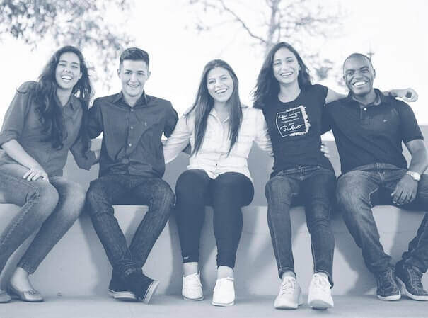 Coworkers sitting together and smiling outside. Coworkers sitting together and smiling outside.