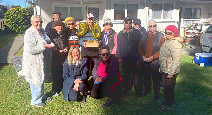 Vincent celebrates his special birthday with his village friends and(front row) Community Manager Tracey John and Midi Rapana ofKaipatiki Community Facilities Trust.