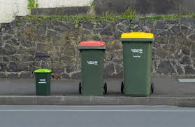 Guide to the correct bin to use. From left, food scraps, general waste, recycling, soft plastics, garden waste.