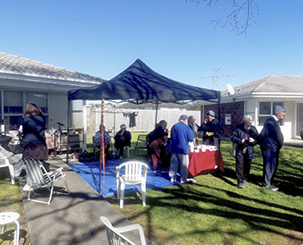 Village meeting under sunny blue skies